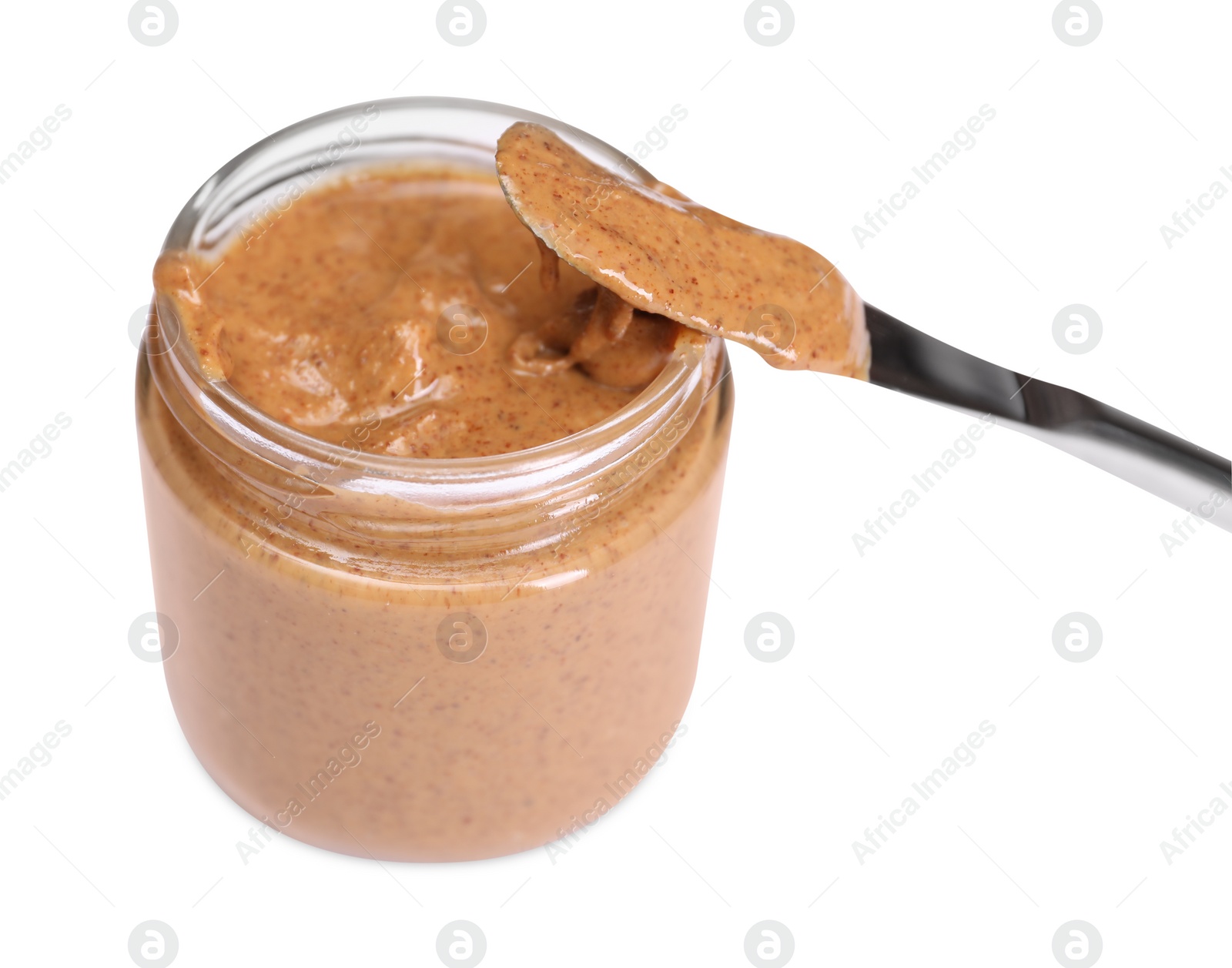 Photo of Tasty nut paste in jar and knife isolated on white