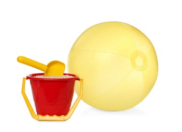 Inflatable yellow beach ball and child plastic toys on white background