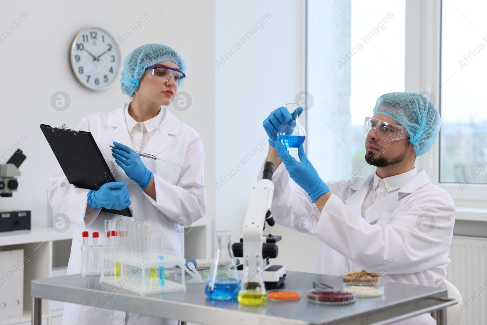 Photo of Quality control. Food inspectors checking safety of products in laboratory