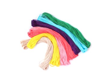 Set of colorful embroidery threads on white background, top view