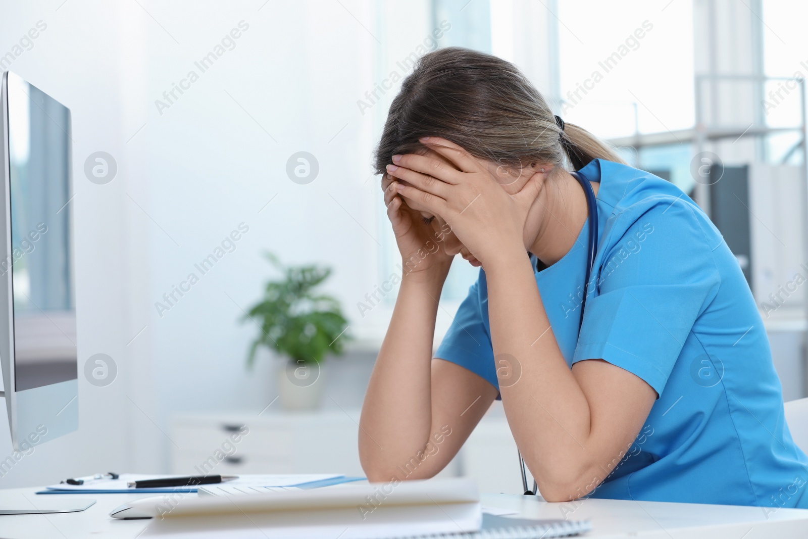 Photo of Exhausted doctor at workplace in hospital, space for text