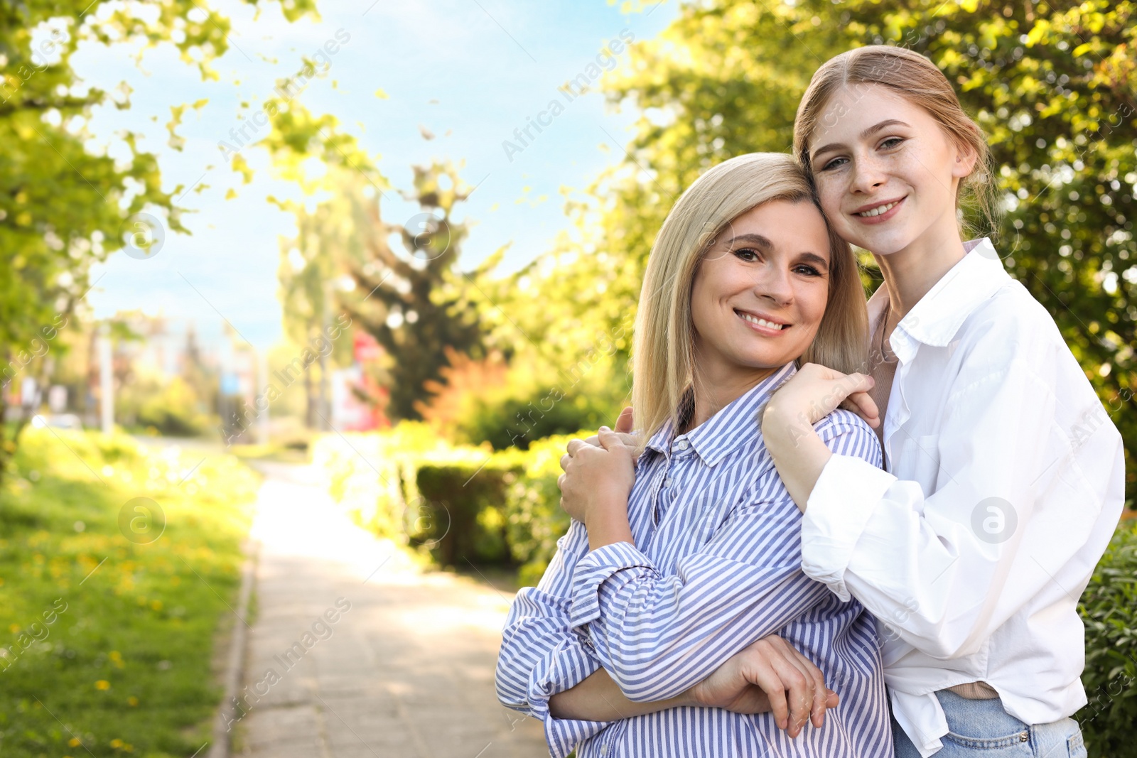 Photo of Happy mother with her daughter spending time together in park on sunny day