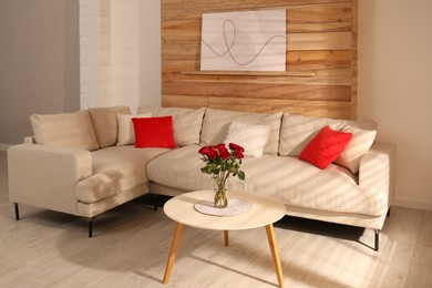 Photo of Modern comfortable sofa near wall in room. Interior design