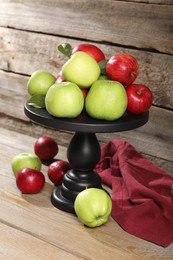 Photo of Fresh ripe red and green apples on wooden table