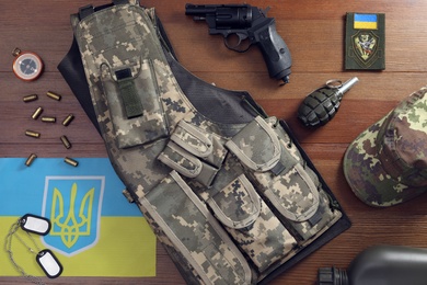 MYKOLAIV, UKRAINE - SEPTEMBER 26, 2020: Tactical gear and Ukrainian flag on table, flat lay