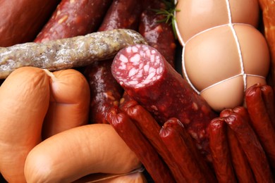Photo of Different types of tasty sausages as background, closeup