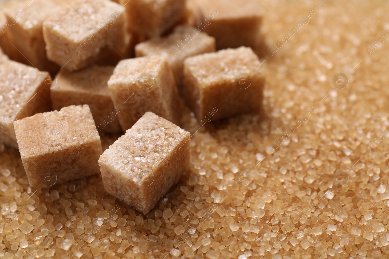 Photo of Different types of brown sugar as background, closeup. Space for text