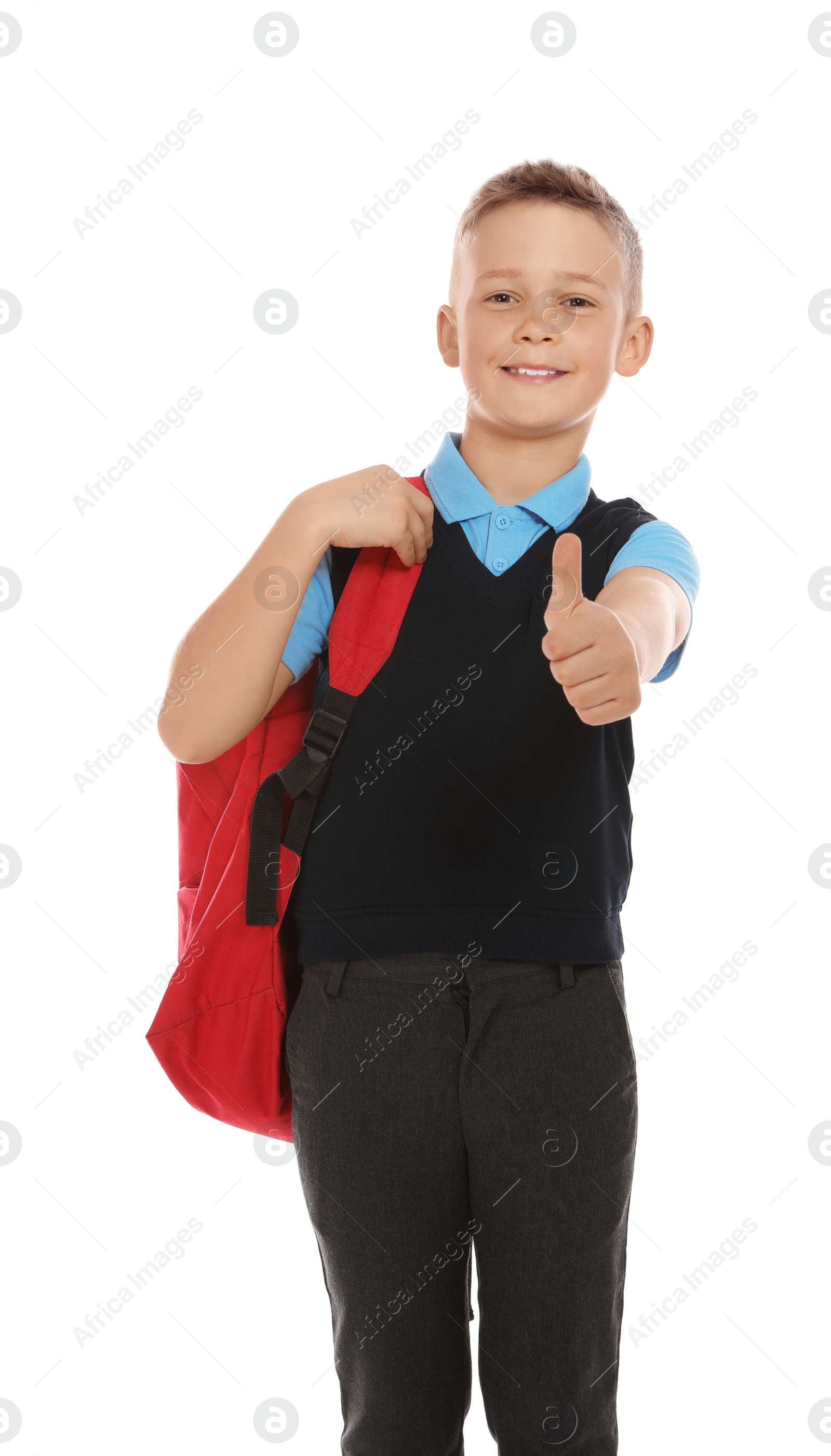 Photo of Portrait of cute boy in school uniform with backpack on white background
