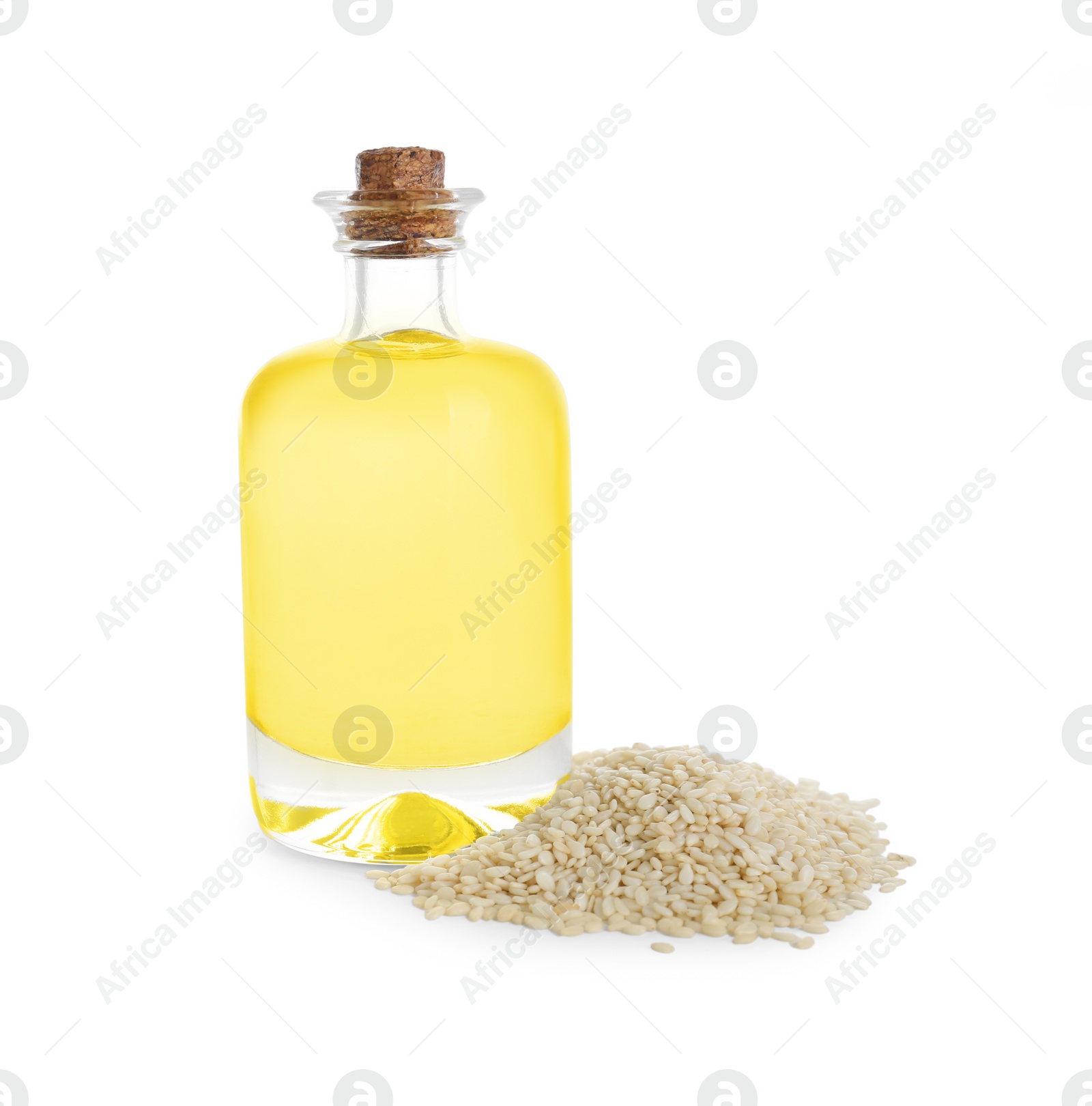 Photo of Glass bottle with fresh sesame oil and seeds isolated on white