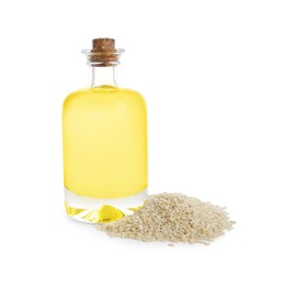 Photo of Glass bottle with fresh sesame oil and seeds isolated on white