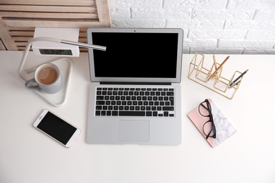 Modern workplace with laptop on table, above view. Mockup for design