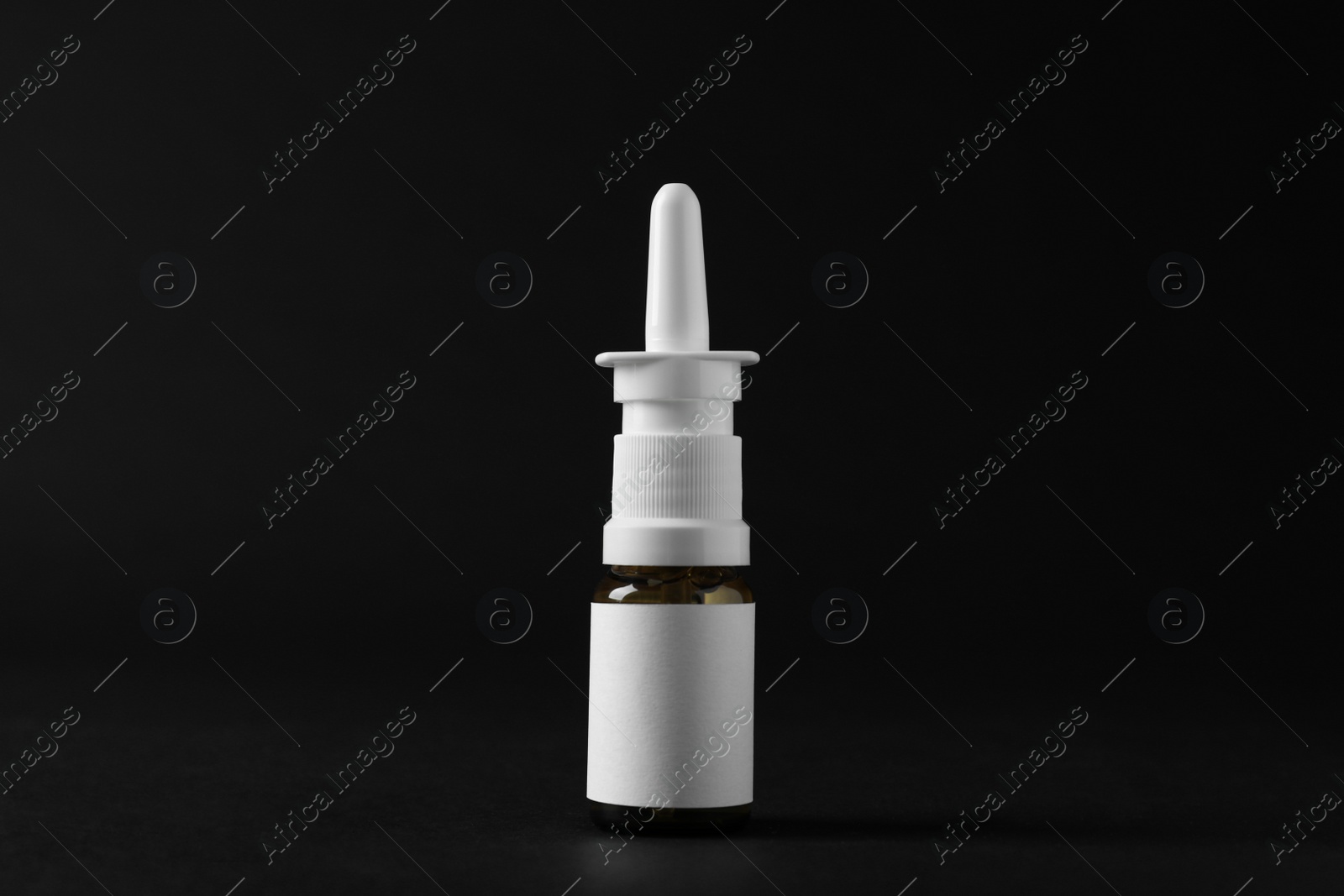 Photo of Bottle of nasal spray on black background