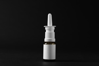 Bottle of nasal spray on black background