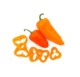 Cut and whole orange hot chili peppers isolated on white, top view