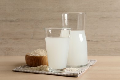 Natural rice water and grains on wooden table