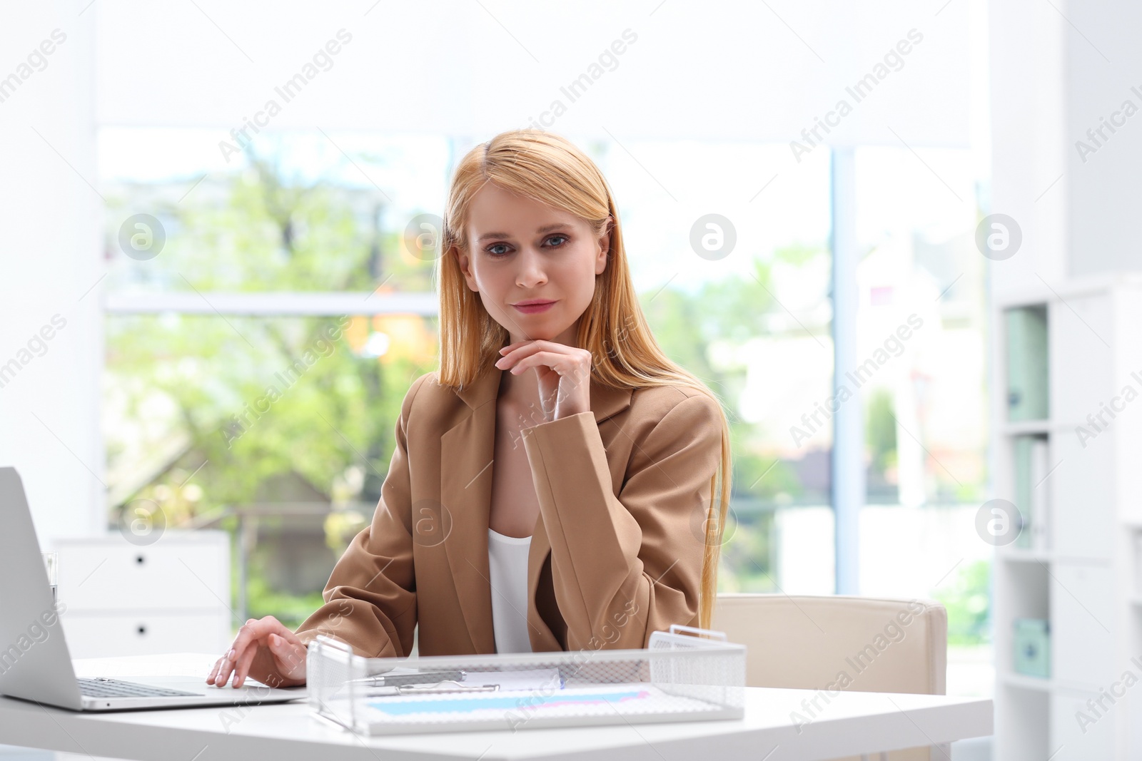 Photo of Professional lawyer working on laptop at table in office