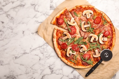 Flat lay composition with delicious pizza baked in oven on marble table, space for text