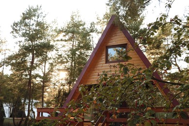 Picturesque view of modern wooden house with veranda in forest