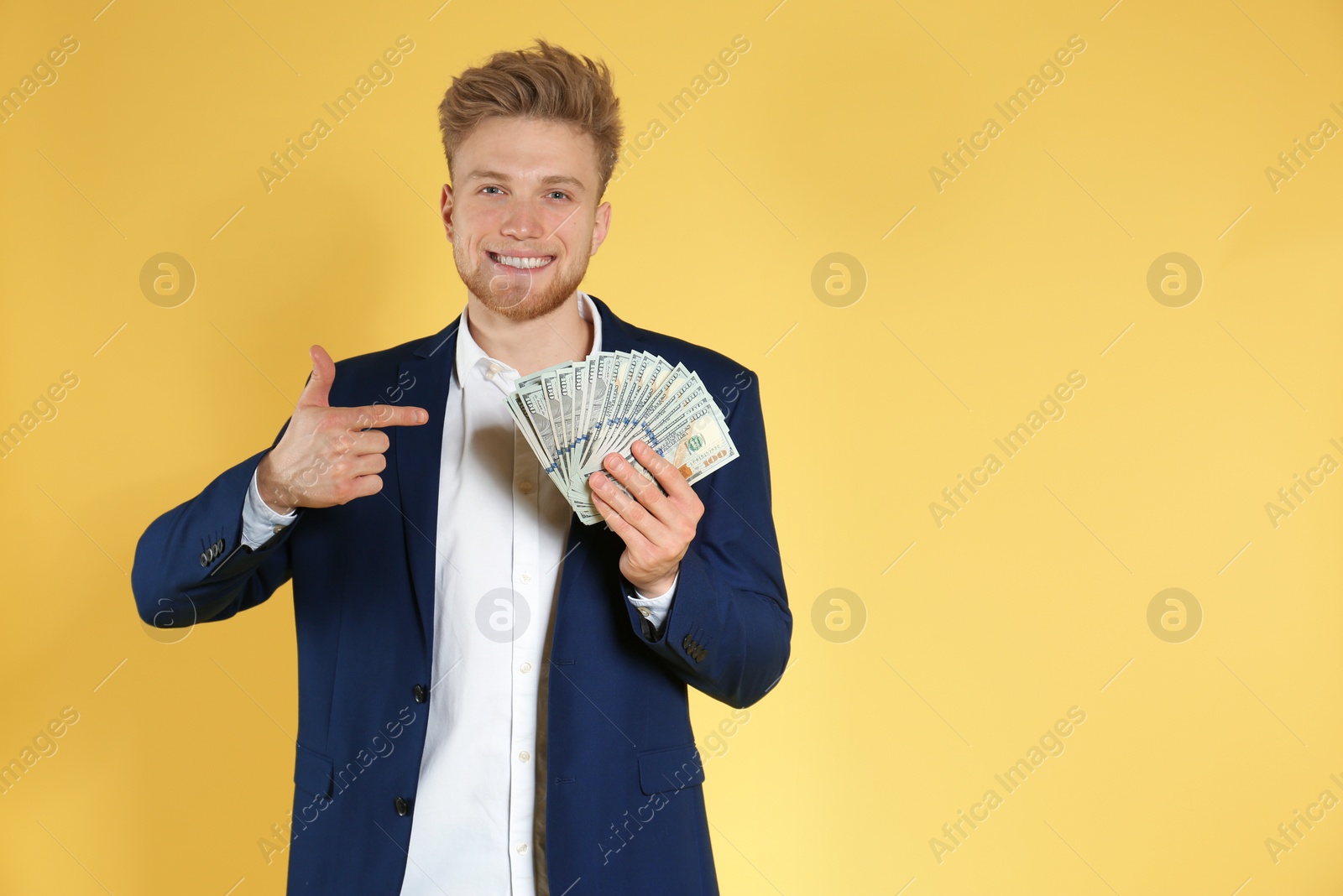 Photo of Businessman with money on color background. Space for text