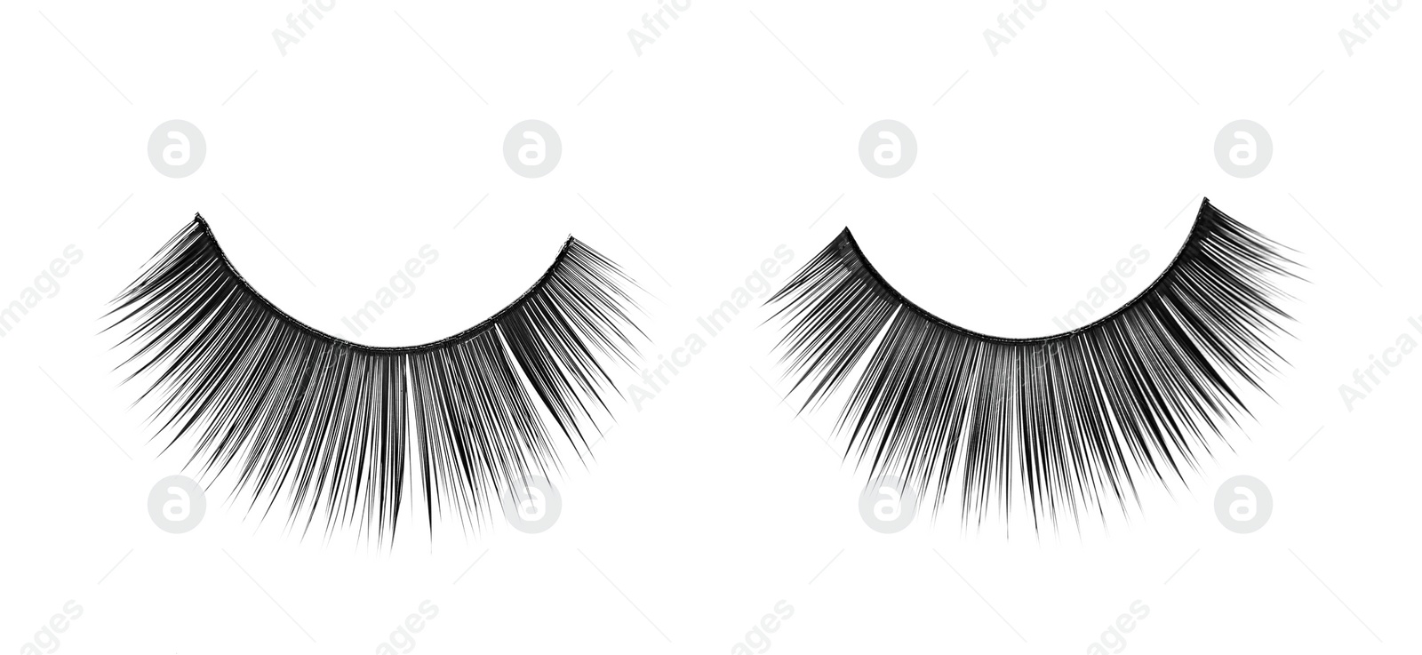 Photo of Fake eyelashes on white background, top view. Makeup product