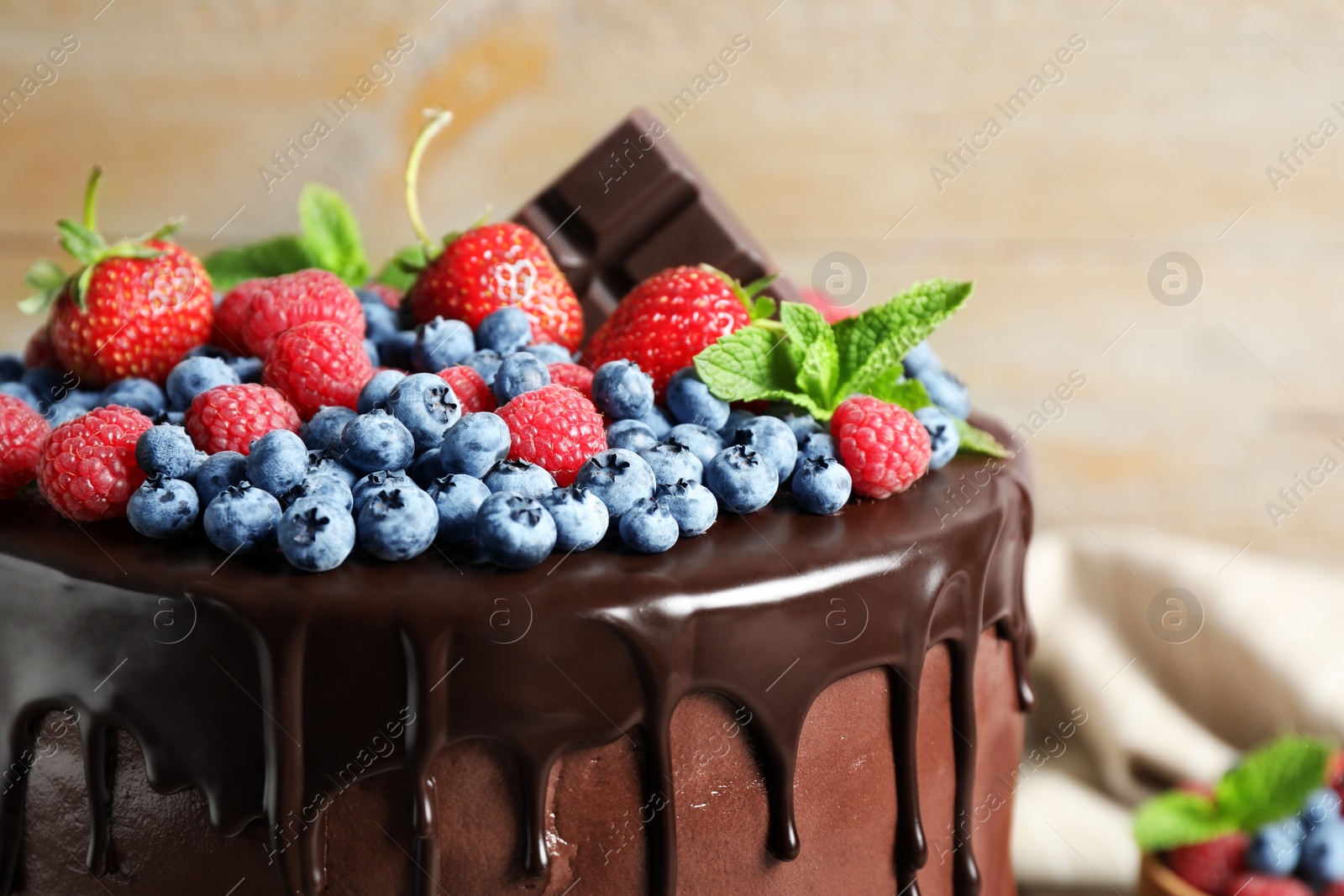 Photo of Delicious chocolate cake decorated with fresh berries, closeup