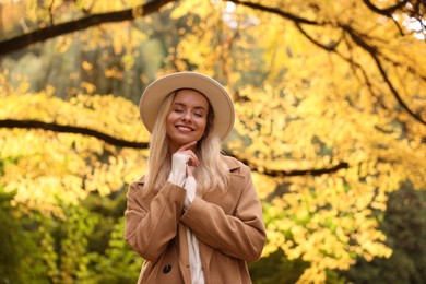 Portrait of happy woman in autumn park