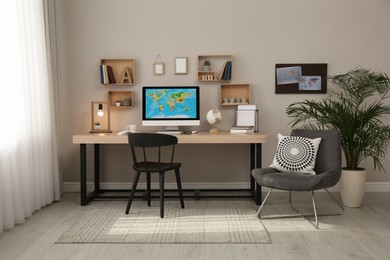 Room interior with comfortable workplace. Modern computer on wooden desk