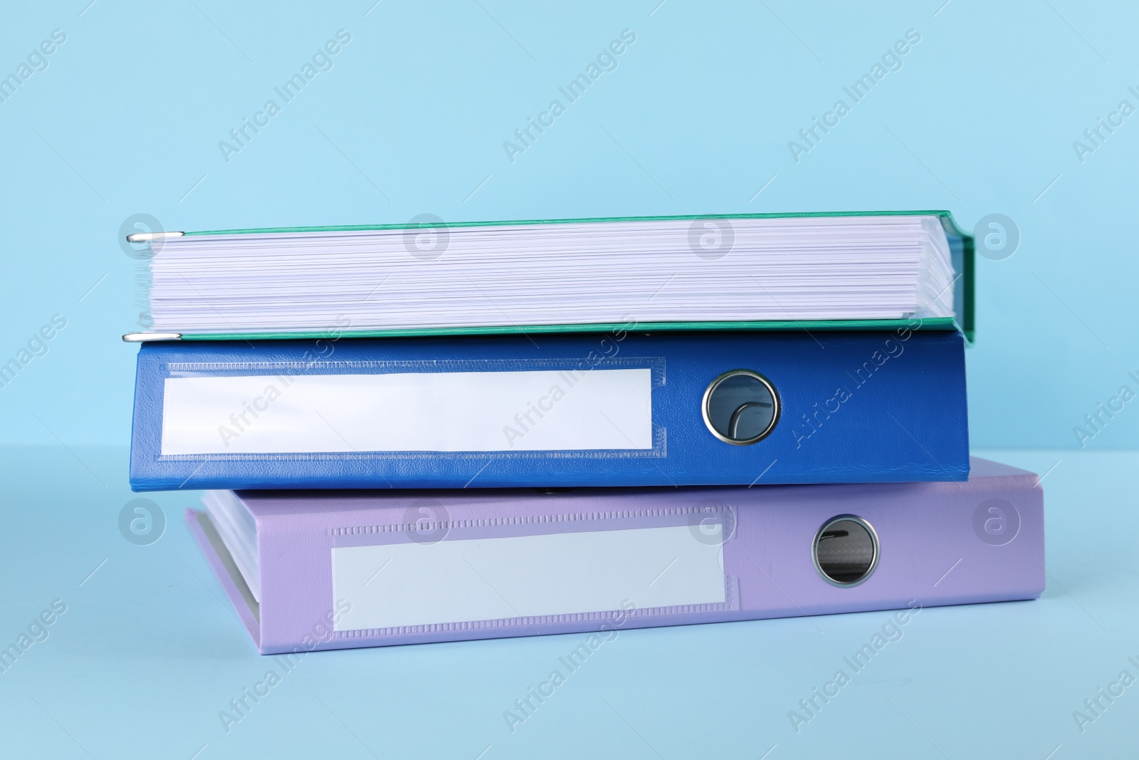 Photo of Stack of office folders on light blue background