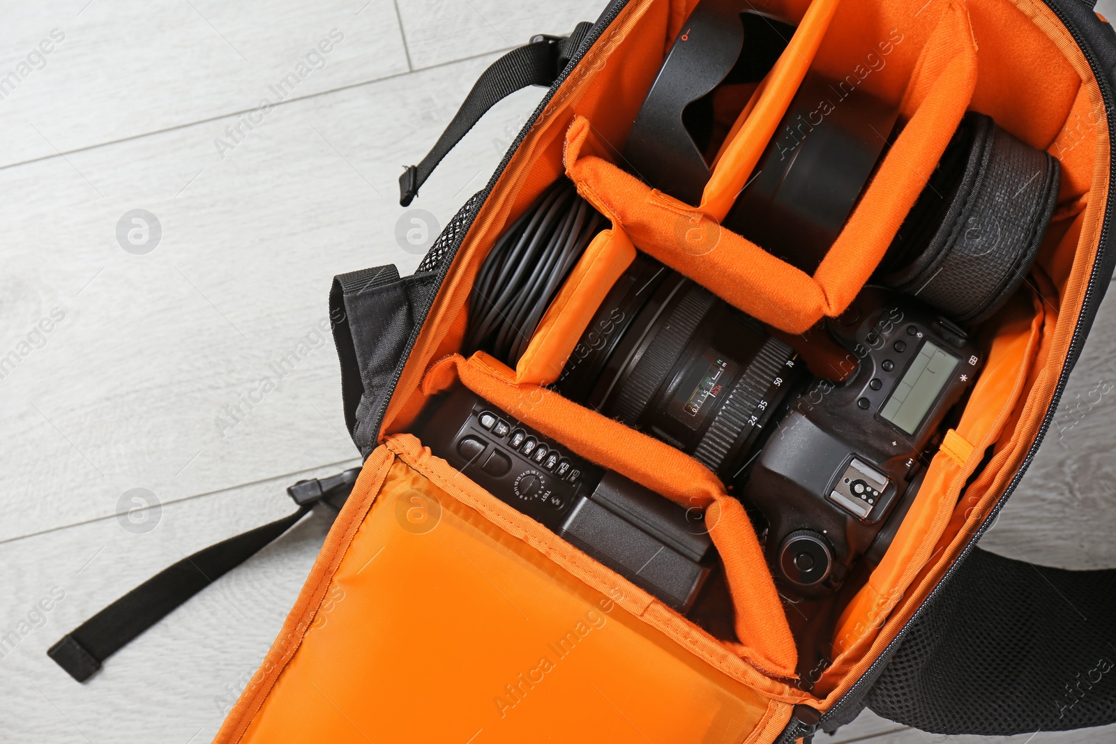 Photo of Bag with digital camera on floor. Professional photographer's equipment