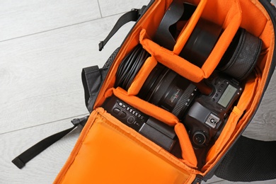 Bag with digital camera on floor. Professional photographer's equipment