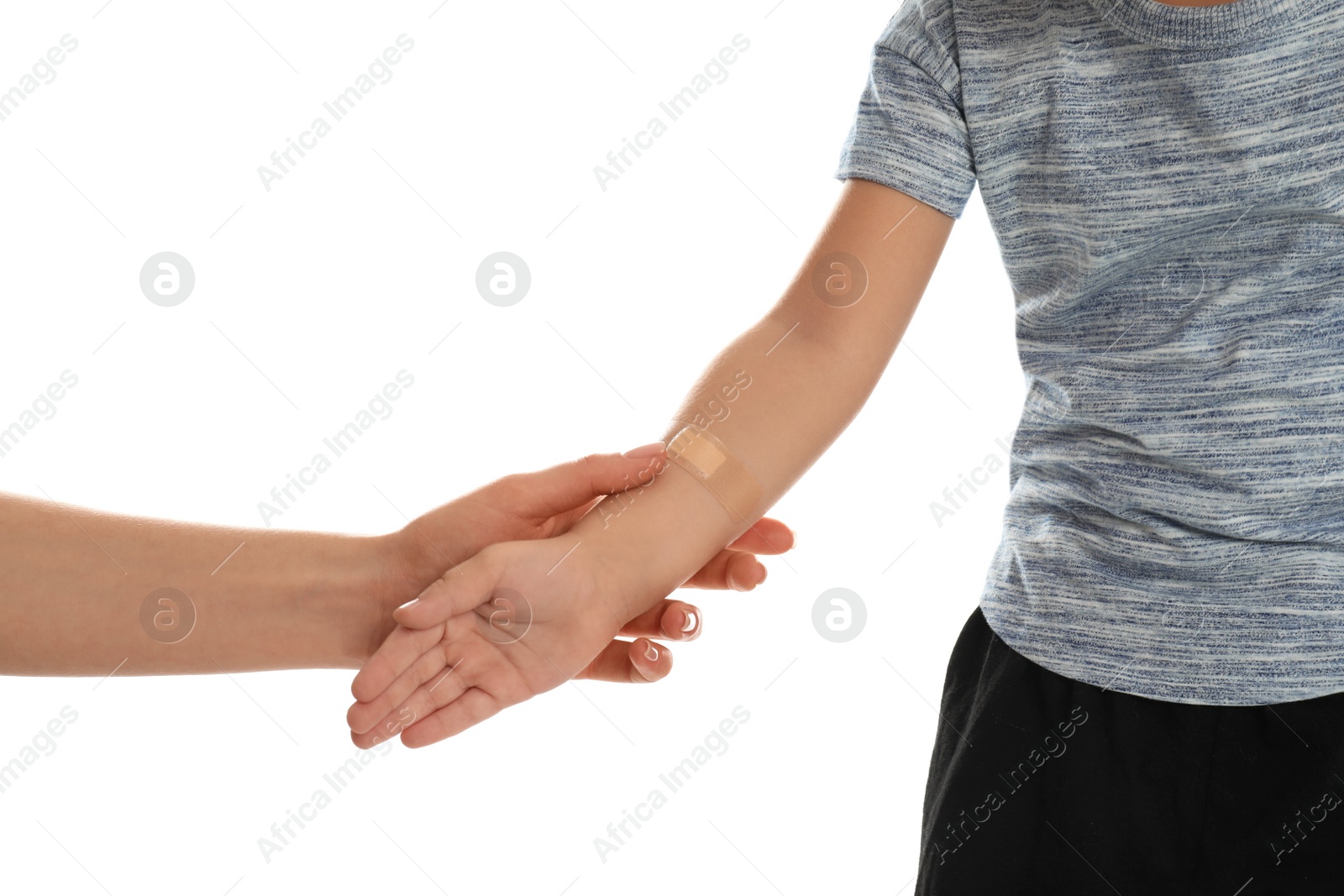 Photo of Mother holding son with sticking plaster by hand on white background, closeup