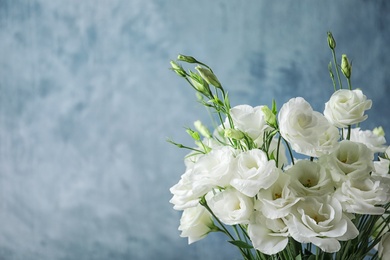 Photo of Beautiful bouquet of Eustoma flowers on color background, close up view