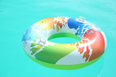 Inflatable ring in swimming pool on sunny day