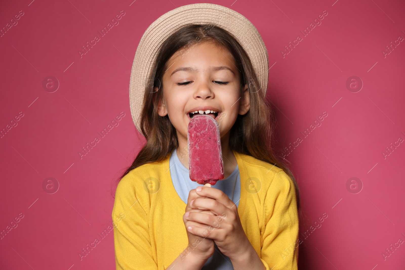 Photo of Adorable little girl with delicious ice cream against color background