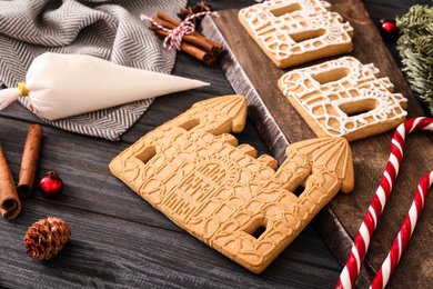 Photo of Composition with parts of gingerbread parts on black wooden table