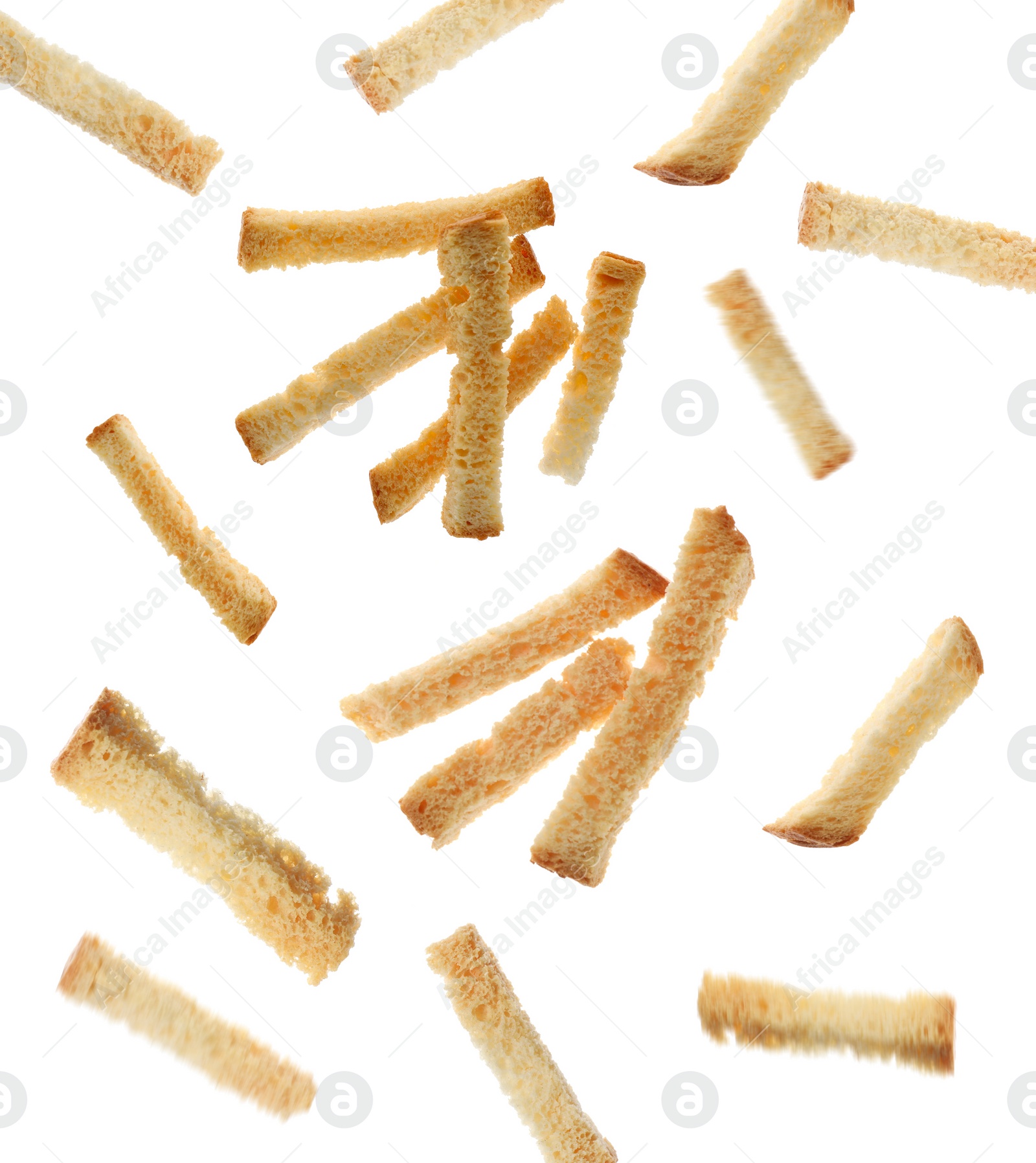 Image of Delicious crispy rusks falling on white background