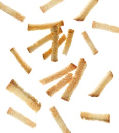 Image of Delicious crispy rusks falling on white background