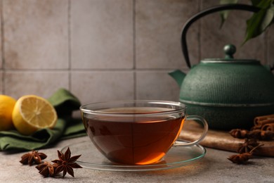 Aromatic tea with anise stars on light grey table