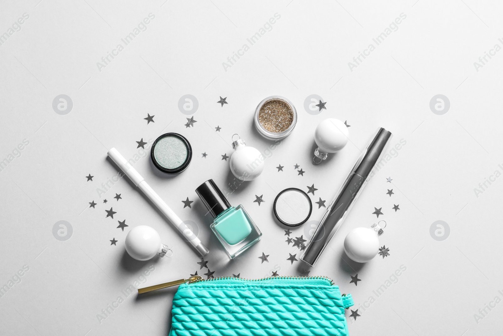 Photo of Flat lay composition with makeup products and Christmas decor on white background