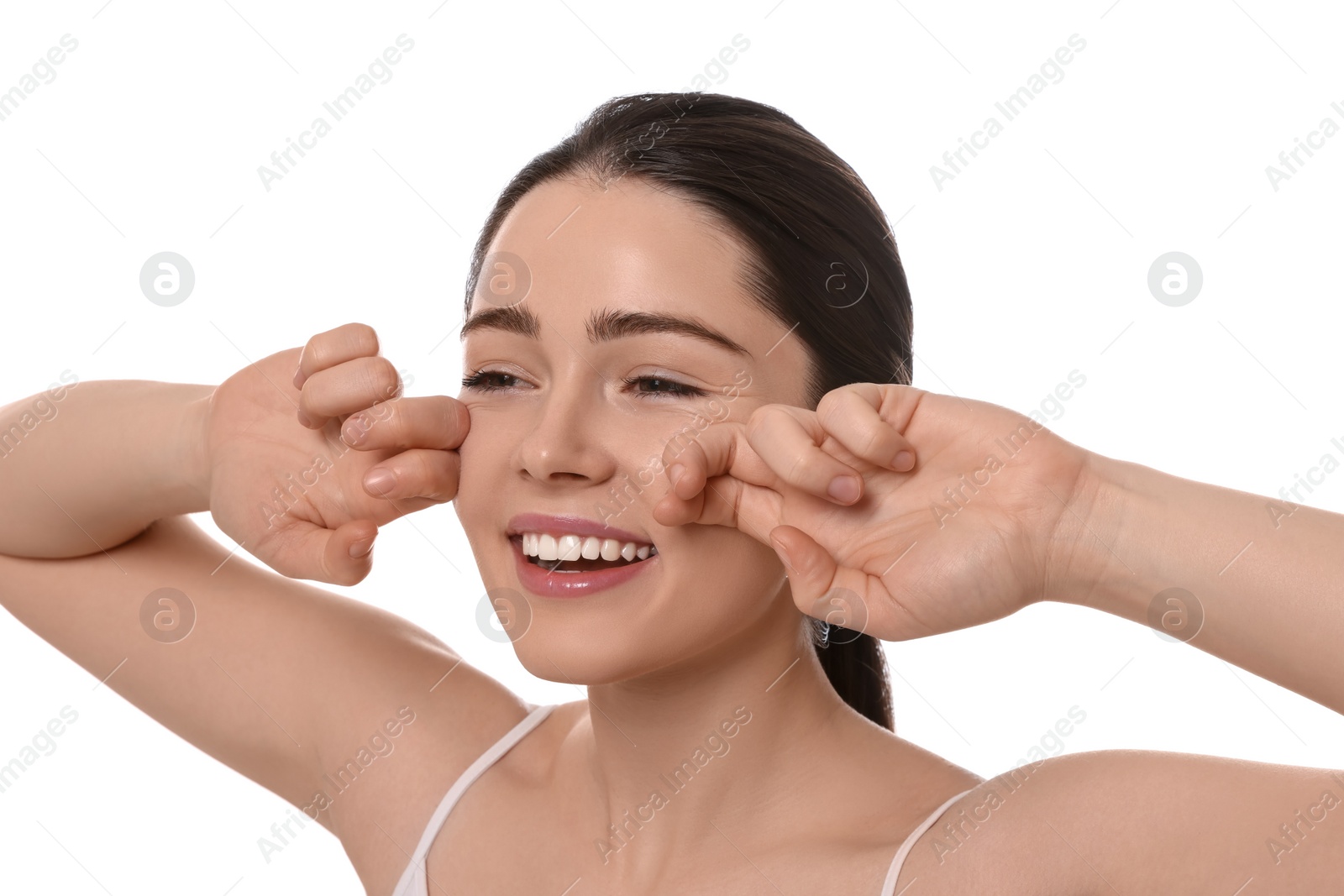 Photo of Young woman massaging her face on white background