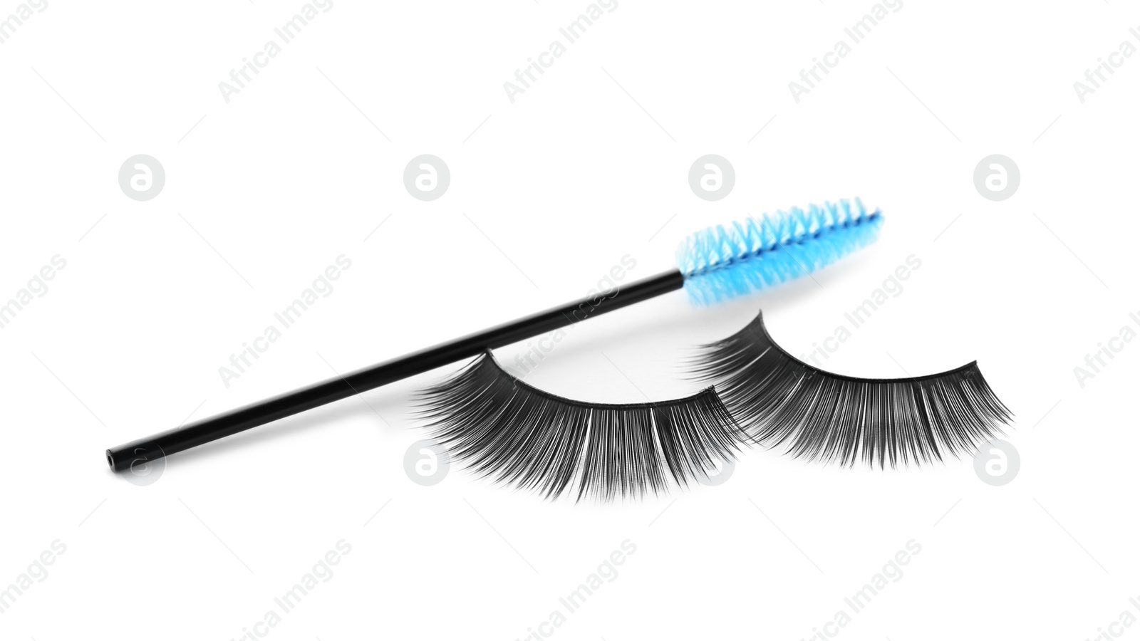 Photo of Fake eyelashes and brush on white background