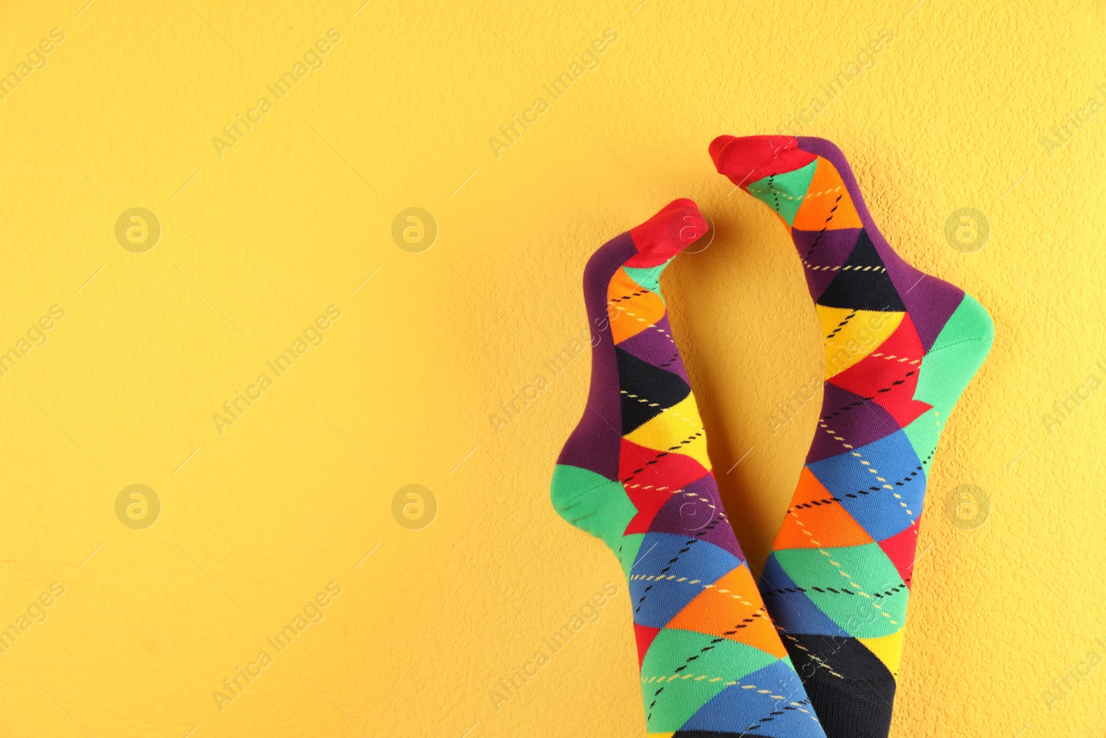 Photo of Woman wearing stylish socks and space for design on color background