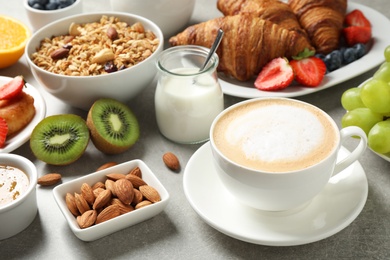 Photo of Buffet service. Tasty breakfast served on light grey table