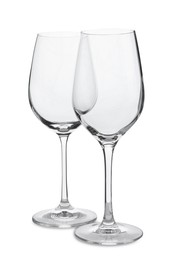 Photo of Elegant clean empty wineglasses on white background