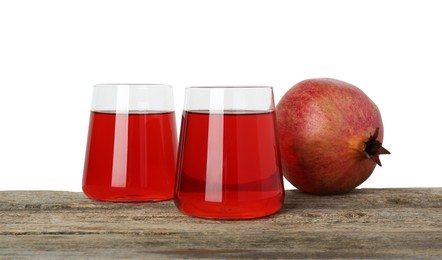 Photo of Refreshing pomegranate juice in glasses and fruit on wooden table against white background