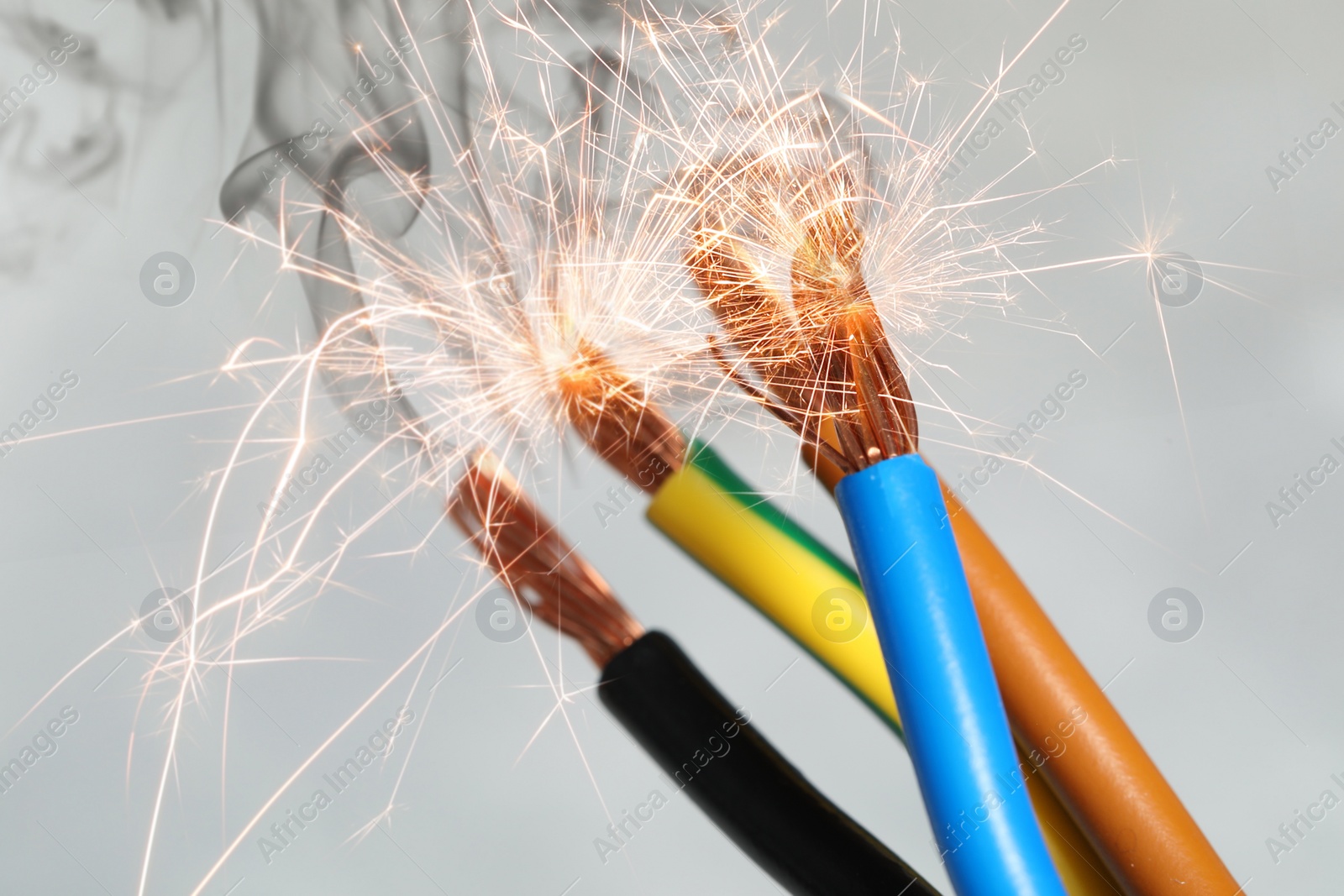 Image of Sparking wiring on blurred background, closeup view