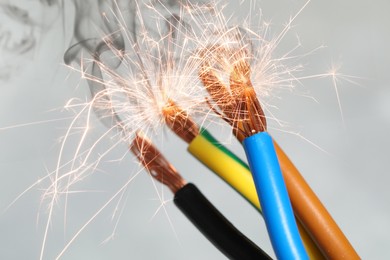 Image of Sparking wiring on blurred background, closeup view