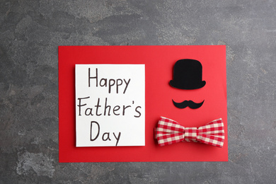 Greeting card with words HAPPY FATHER'S DAY on grey stone background, top view