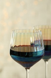 Glasses of red wine on light background, closeup