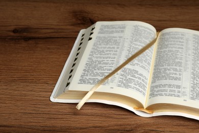 Open Bible on wooden table. Christian religious book